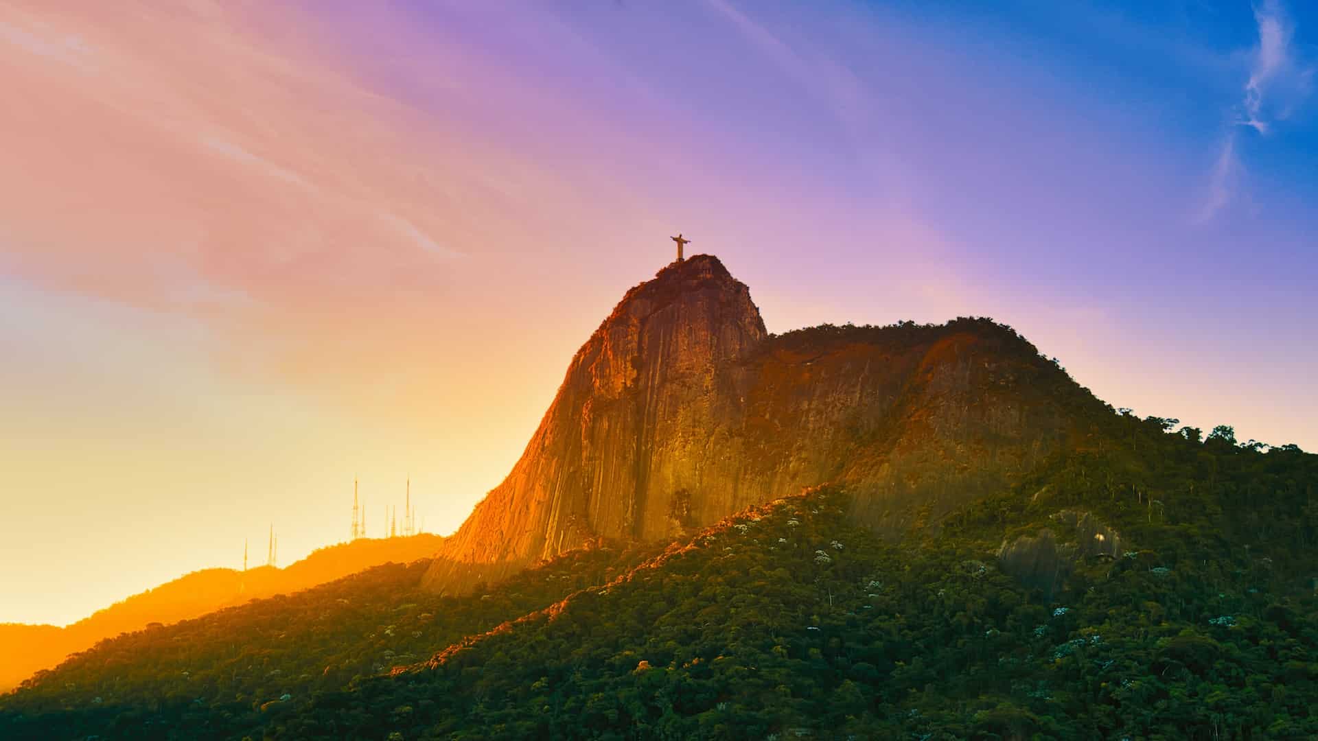 The best time to visit Brazil is when you can catch the sunsets like this one over Christ the Redeemer in Rio de Janeiro. 