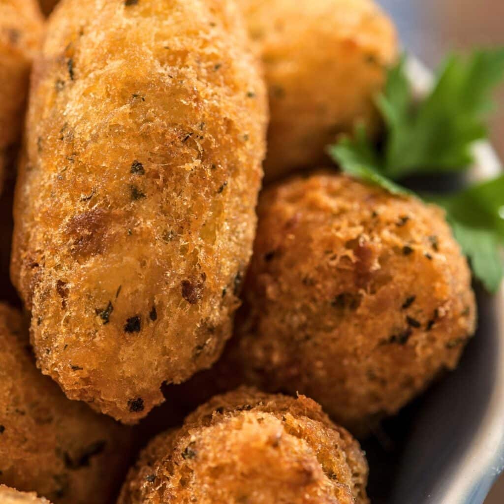 Homemade Brazilian Codfish Cakes, a savory blend of cod and spices, a favorite dish at our Christmas gathering.